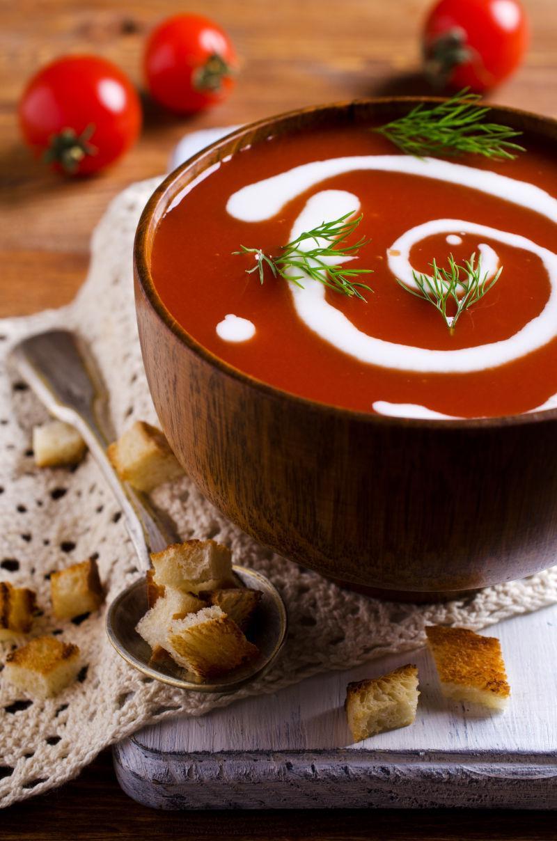 西红柿浓奶油在木制碗中的木制背景