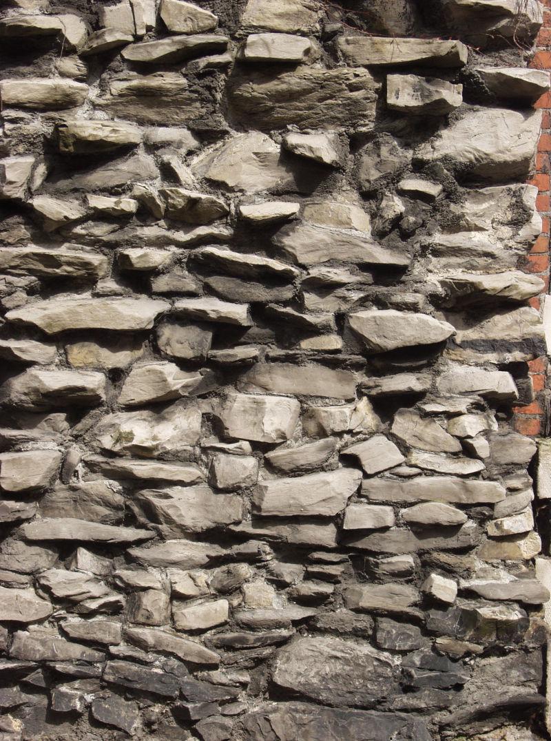 不平整的大块石头石墙背景
