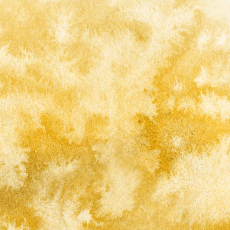 奢华的金色水彩画ombre泄漏并在白色水彩纸背景上泼洒纹理