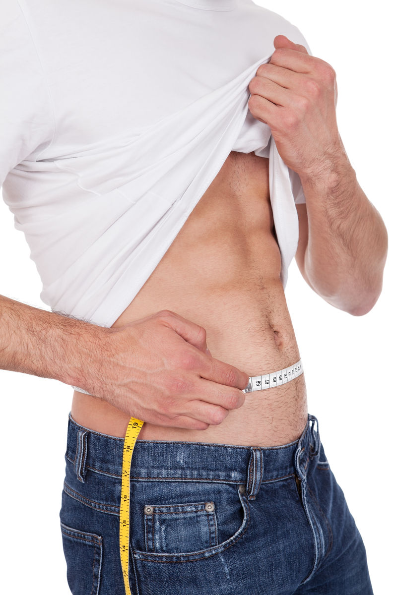 肌肉发达的年轻人测量腰围白色隔离