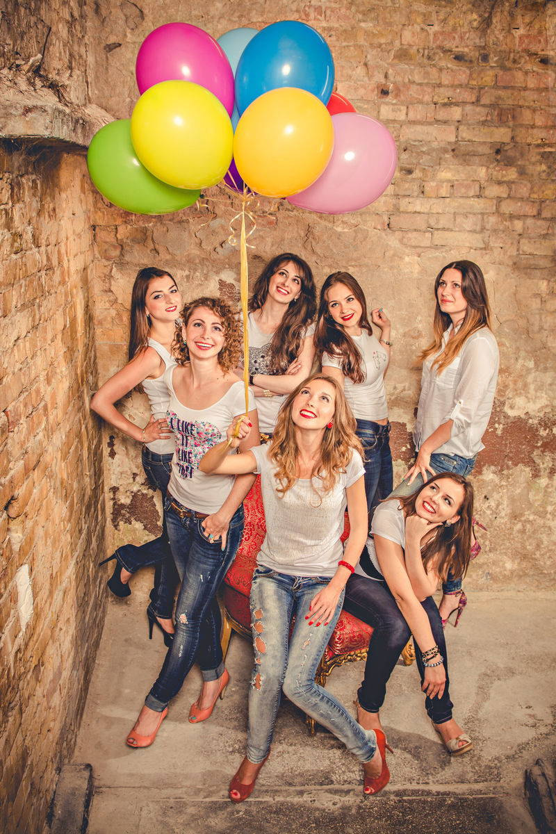 有趣的漂亮女孩拿着生日蛋糕气球和礼物