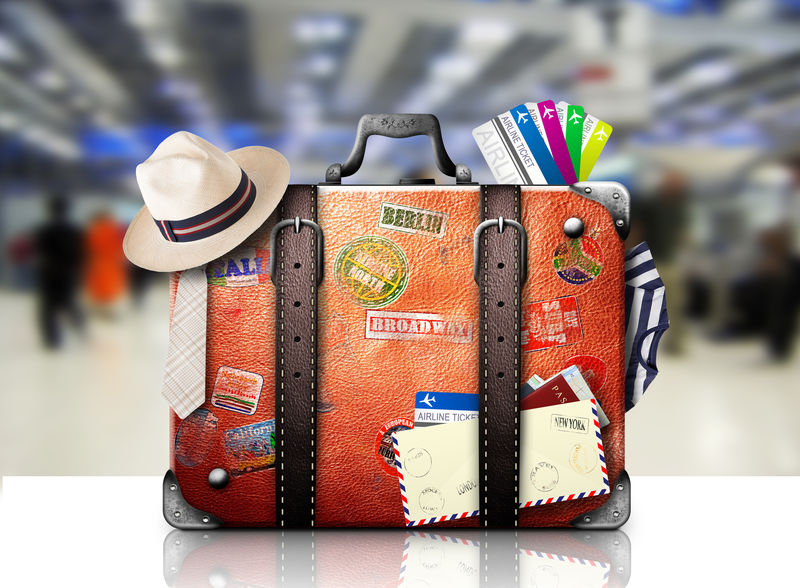 带旅行贴纸的旅行者的复古手提箱