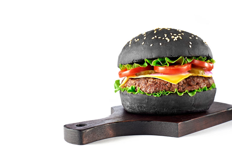 黑色汉堡包木质切割板白色背景