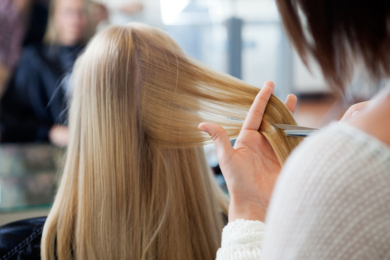 美发师在会客室给女性顾客新发型的特写镜头