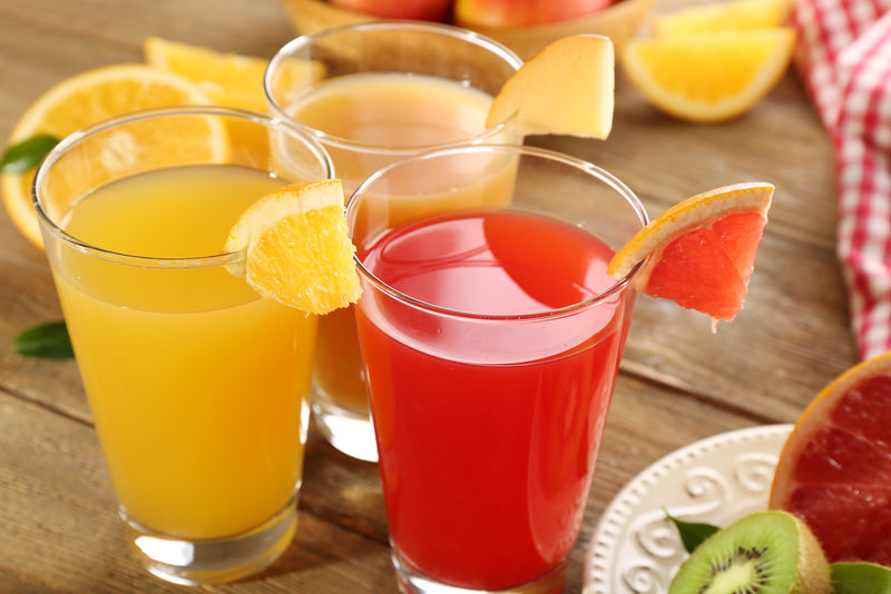 在木桌上放水果的新鲜果汁