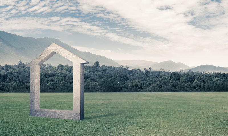 青草上混凝土家居标志的概念背景图像