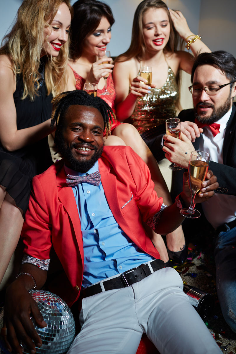 衣冠楚楚的朋友聚在一起庆祝生日：他们兴致勃勃地聊天，喝香槟。