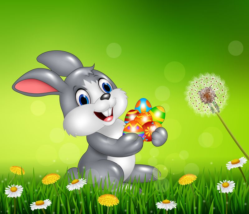 快乐的小兔子在草地上拿着复活节彩蛋
