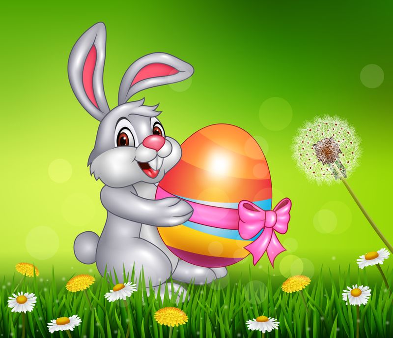 可爱的小兔子在草地上拿着复活节彩蛋