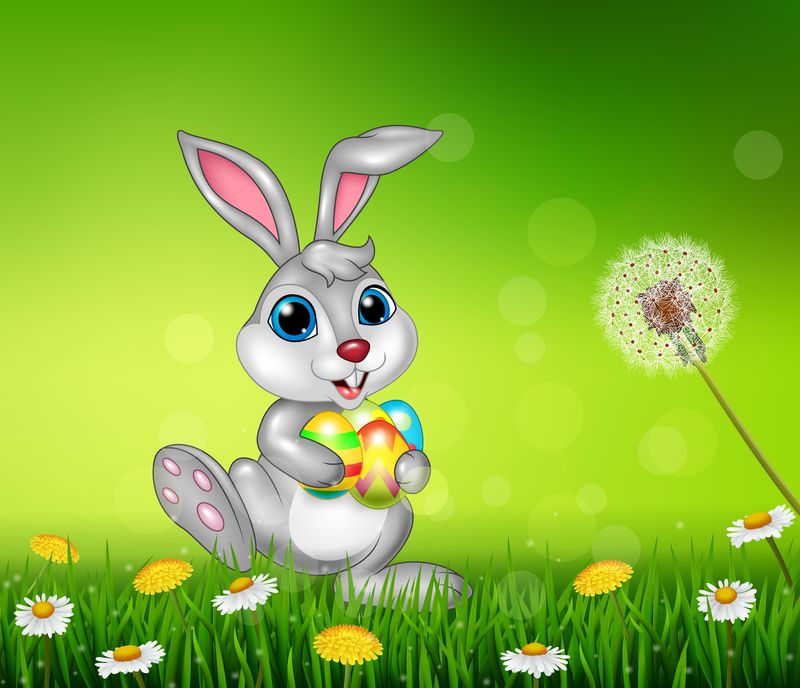 快乐的小兔子在草地上拿着复活节彩蛋