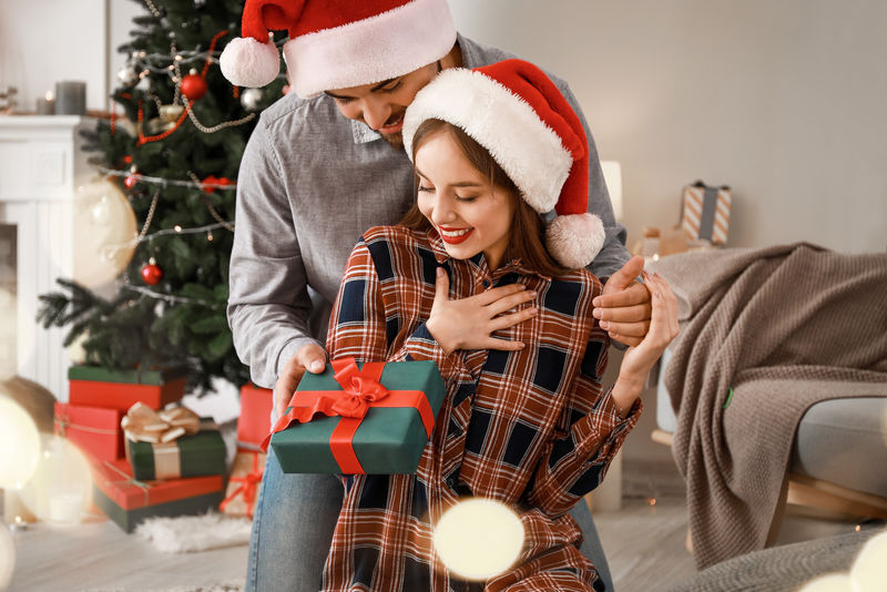 快乐的年轻人在家给他的女朋友送圣诞礼物素材-高清图片-摄影照片-寻图免费打包下载