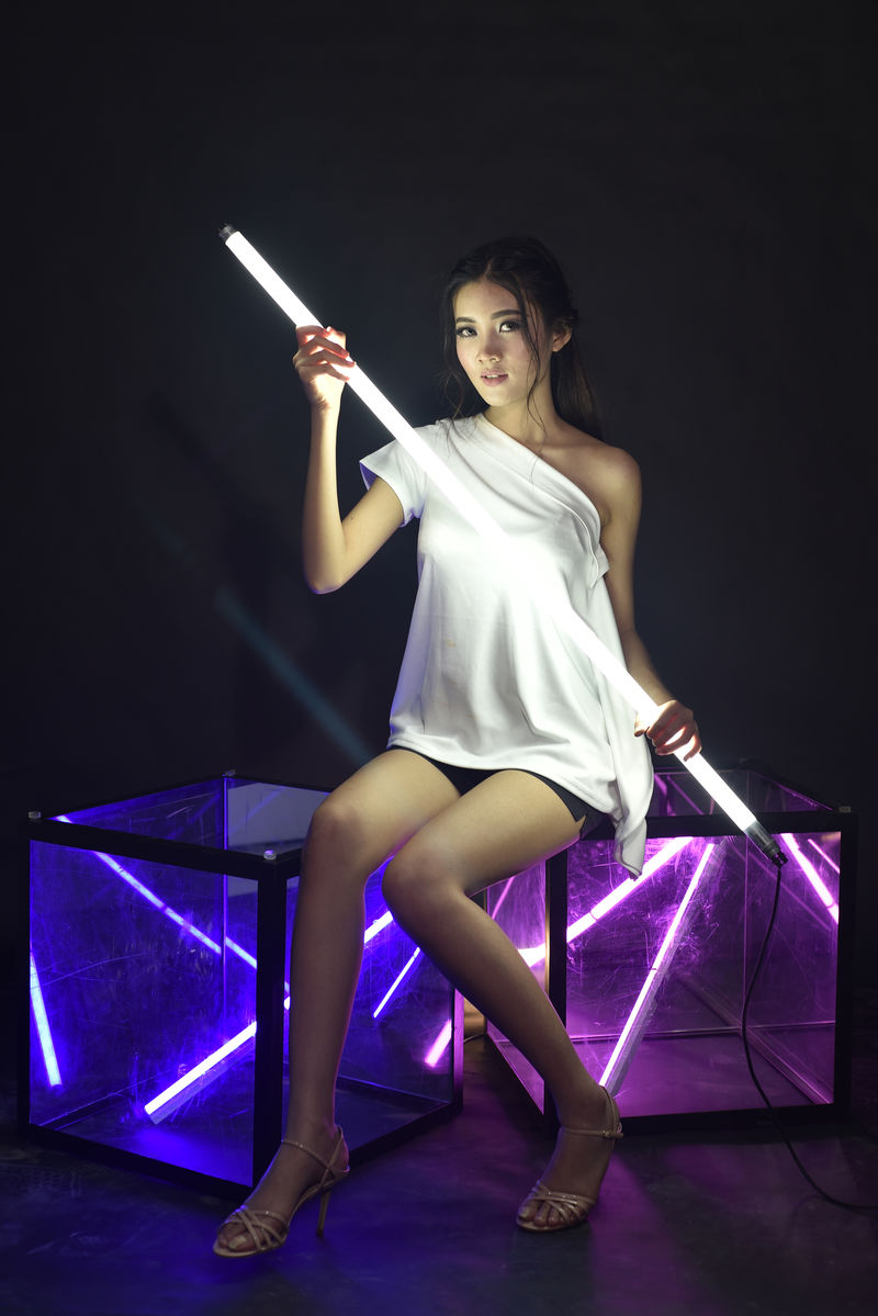 拿着荧光灯管的女人