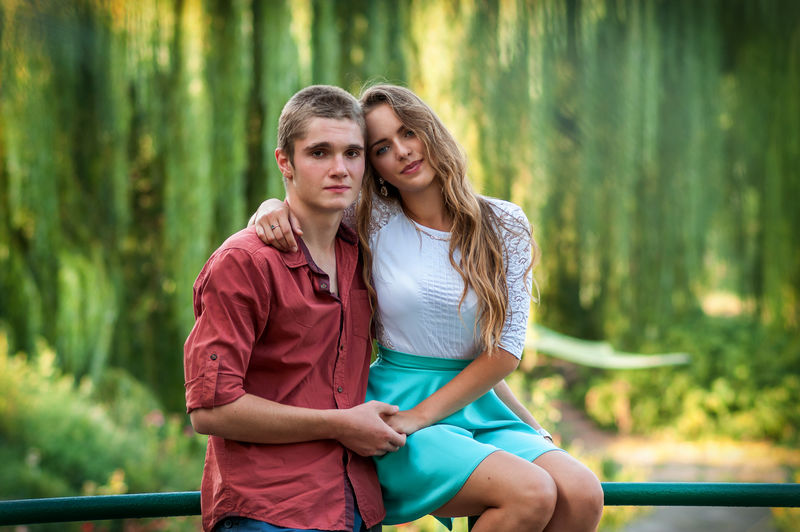 一对情侣在绿色公园对面的画像