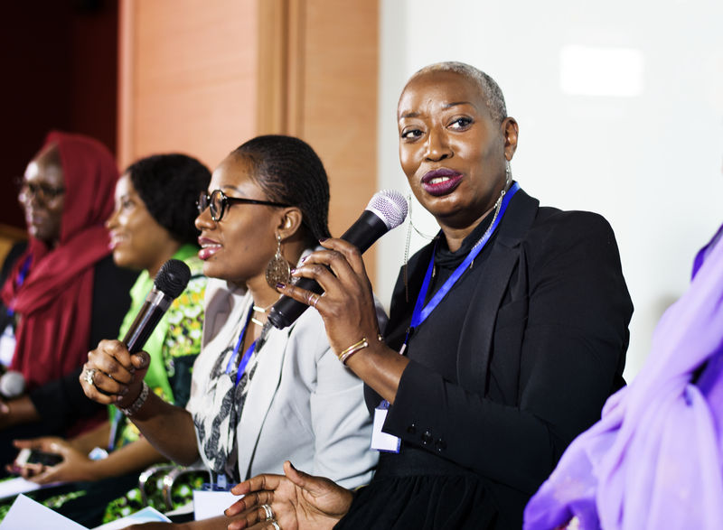 一个中非裔妇女对着麦克风说话