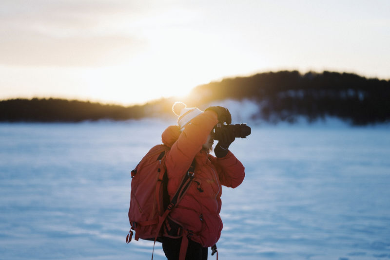 背着背包欣赏日出的摄影师