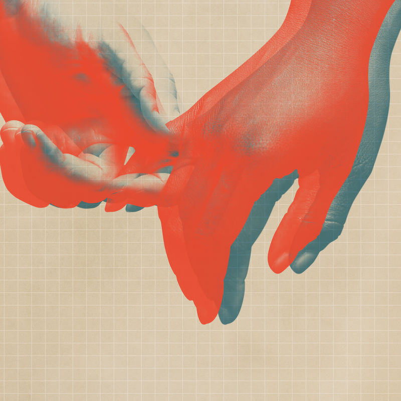 米色网格背景上生动的橙色手拉手特写