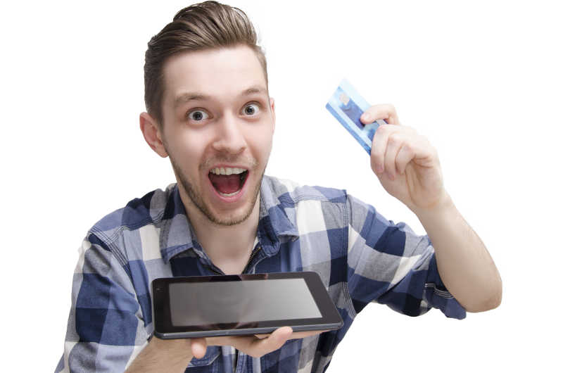 男子拿着信用卡和平板电脑做出惊讶的表情