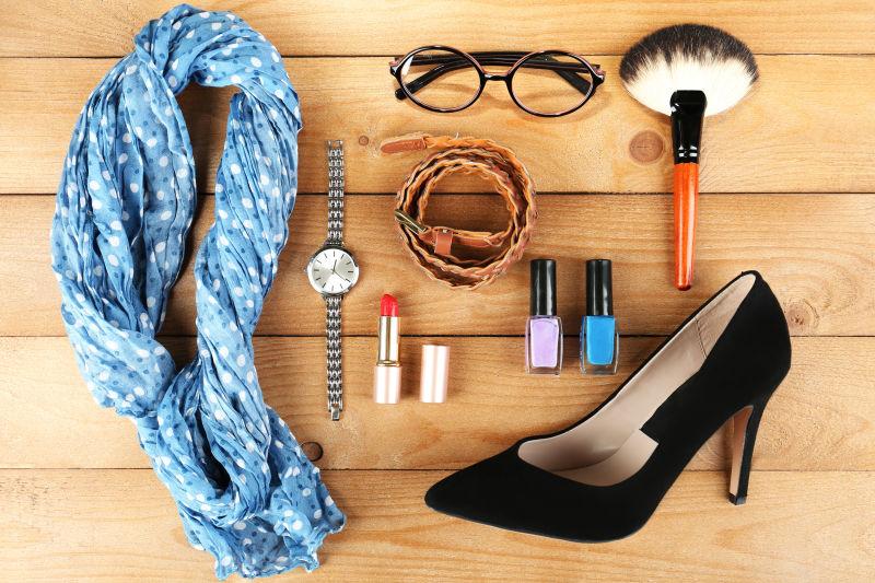 放在木板上的时尚女士的服装配饰和化妆品