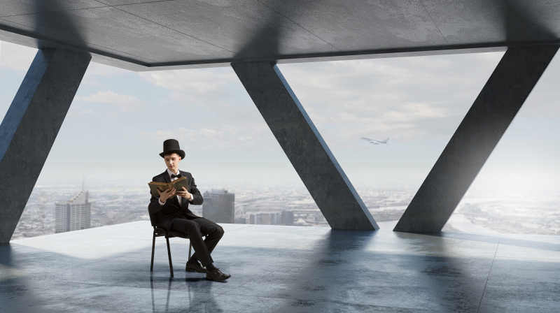 坐在空旷高楼里读书的男人广告