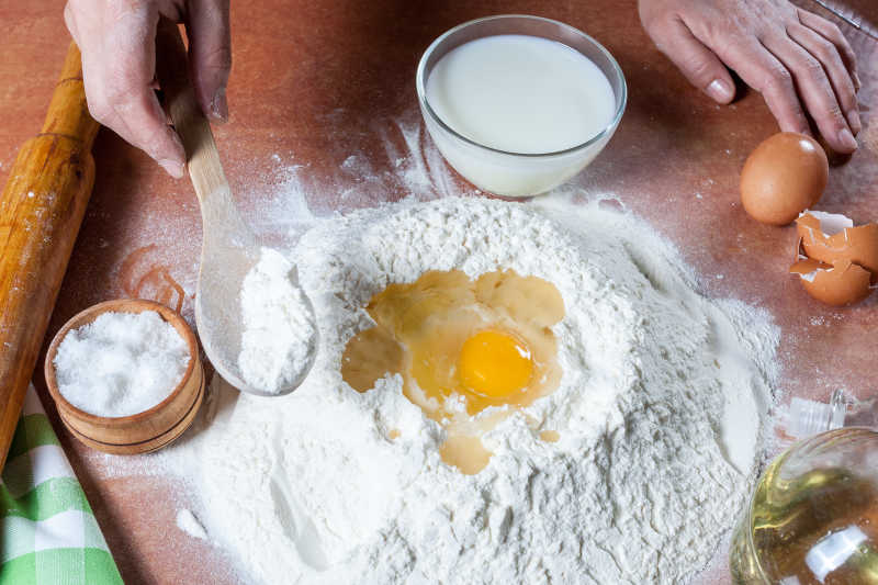 木桌上使用鸡蛋和面团