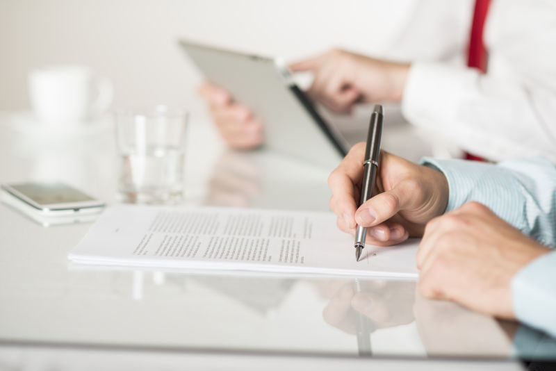 在合同协议上签字的男子