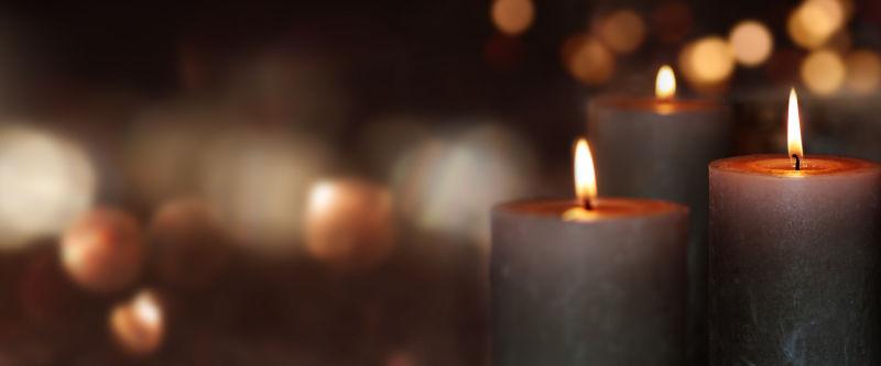 在黑暗的背景下的燃烧的圣诞蜡烛