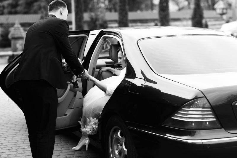 新郎帮助新娘走出黑色奔驰车