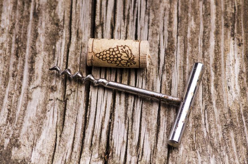 木桌上的开瓶器和红酒瓶木塞