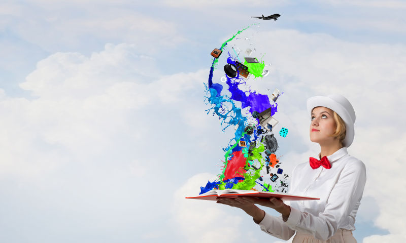 女孩打开书飞出油漆和电子产品